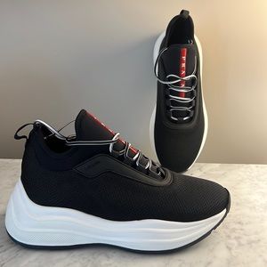 New black & white knit neoprene Prada sneakers with prominently featured logo.